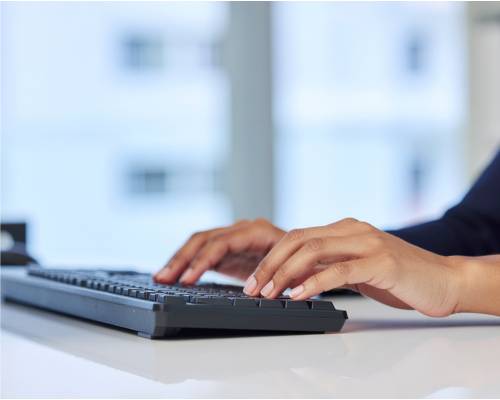 Hands typing on keyboard