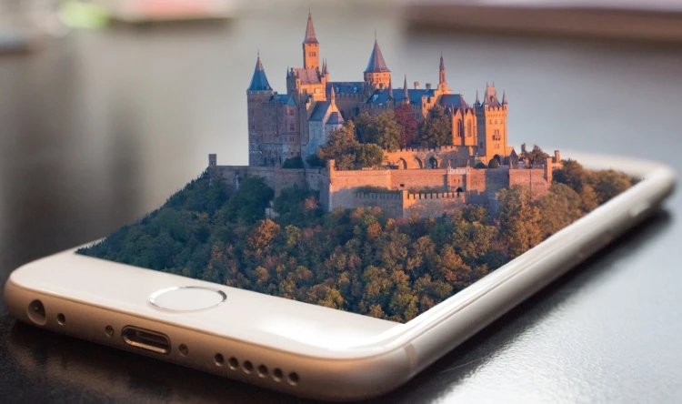 Stock illustration of a castle emerging from a smartphone.