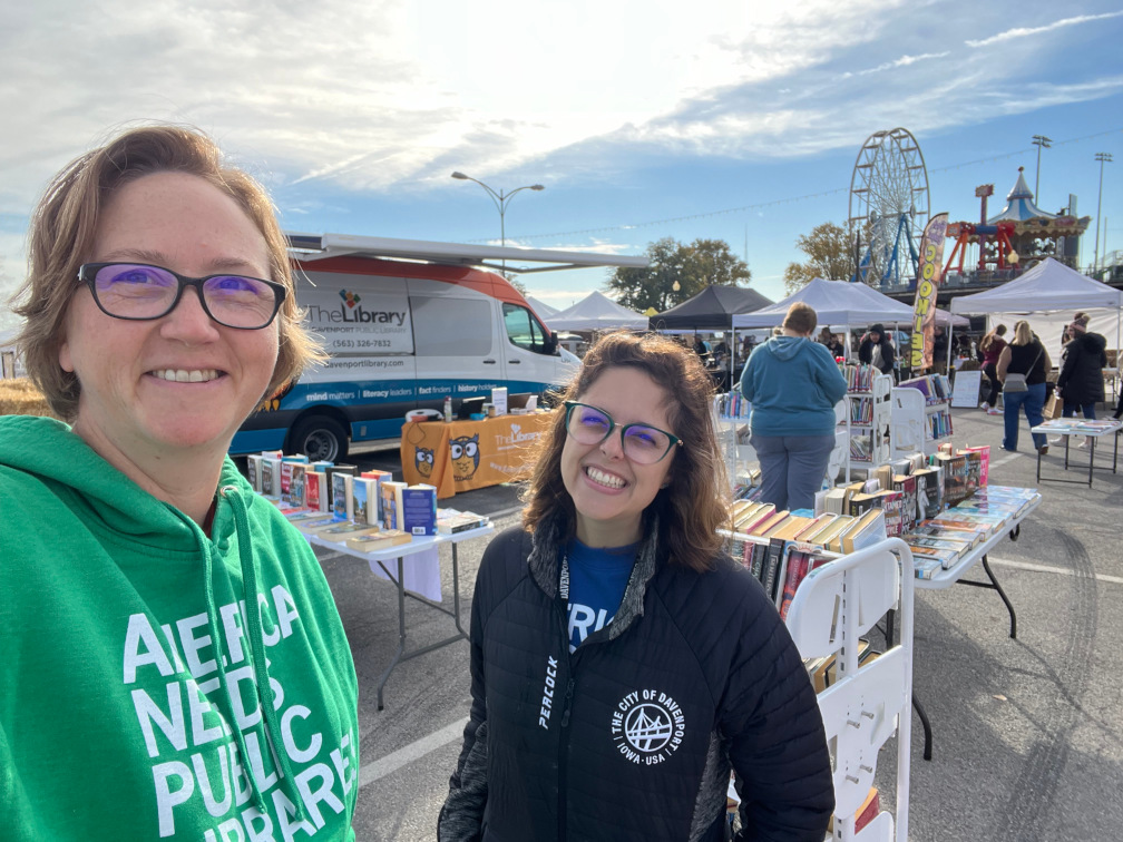 Library staff and Outreach Wheeled Library (OWL) at the Davenport Farmer's Market.
